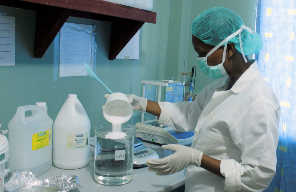 Preparing hand sanitizer at NPH Haiti